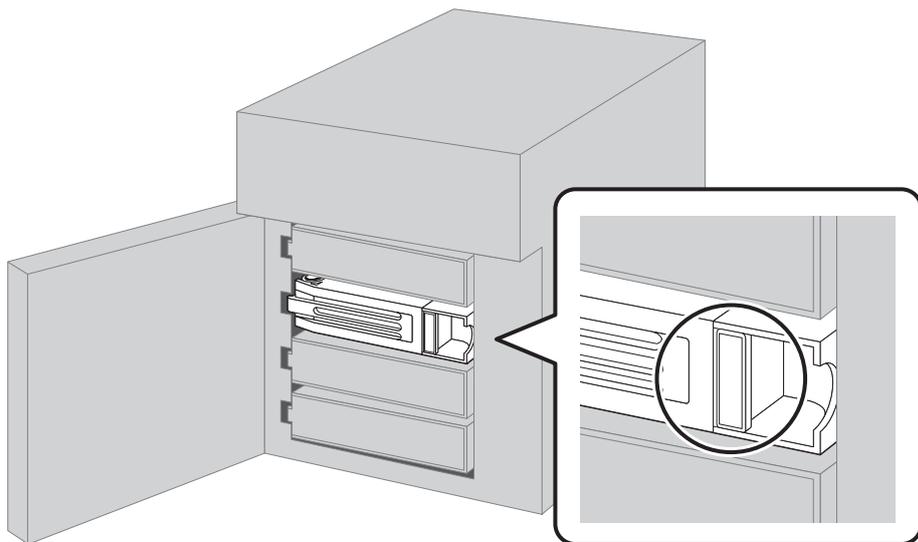 Diagram showing the removal of a drive unit. A 3D perspective view of a server with its front panel open shows a drive unit being pulled out. A circular callout provides a close-up view of the drive's front bezel, highlighting a small rectangular latch or handle that is being pressed to the left to release the drive.